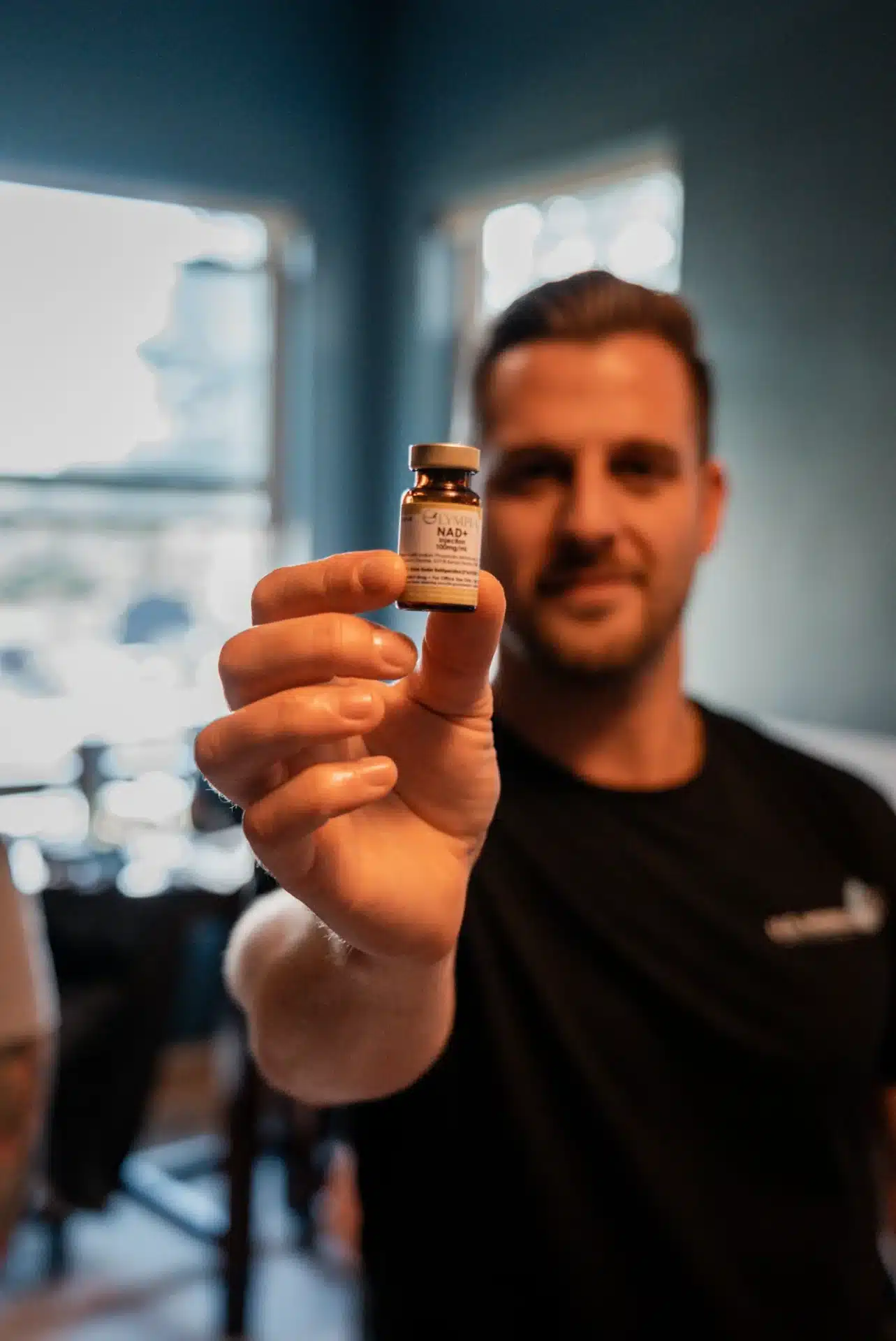 Person Holding NAD Bottle