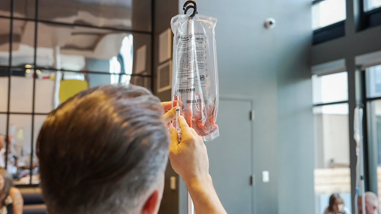 Nurse Adding Vitamins To Bag