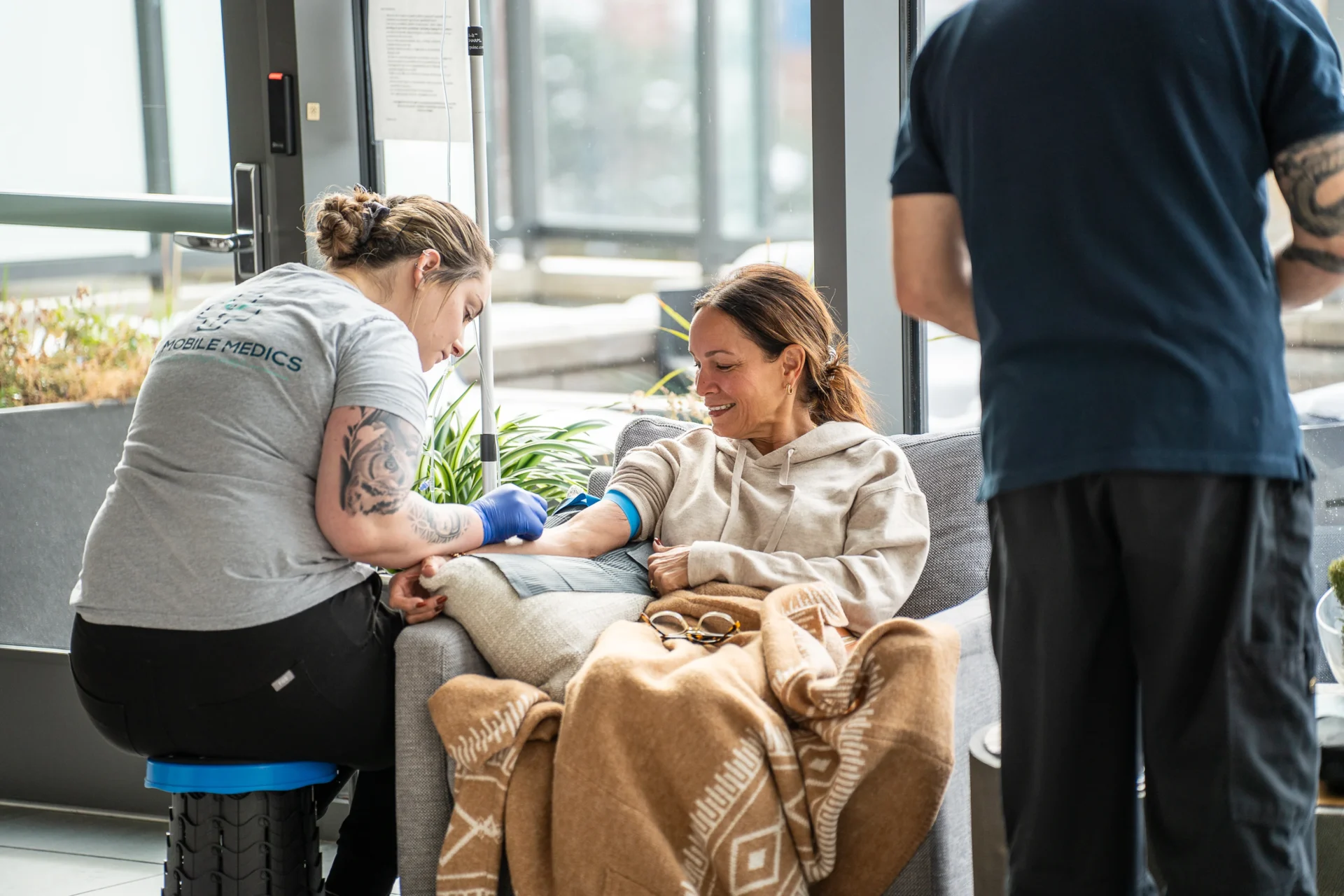 Nurse securing IV line before administration
